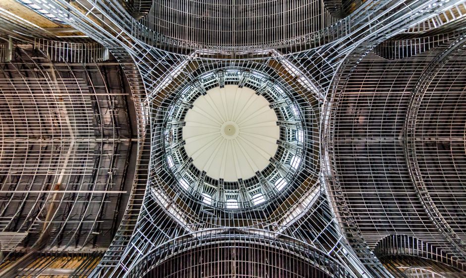 Intricate dome ceiling showcasing modern architecture with a symmetrical design from a low angle view.